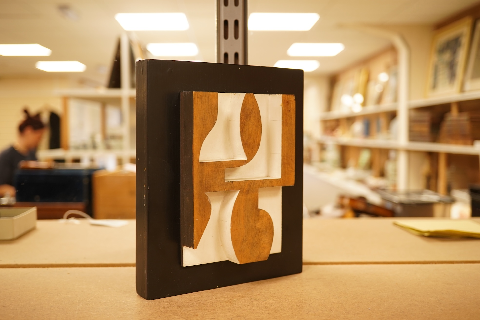 Donald Wells, a carved oak relief sculpture with gallery leaflet, 19cm high